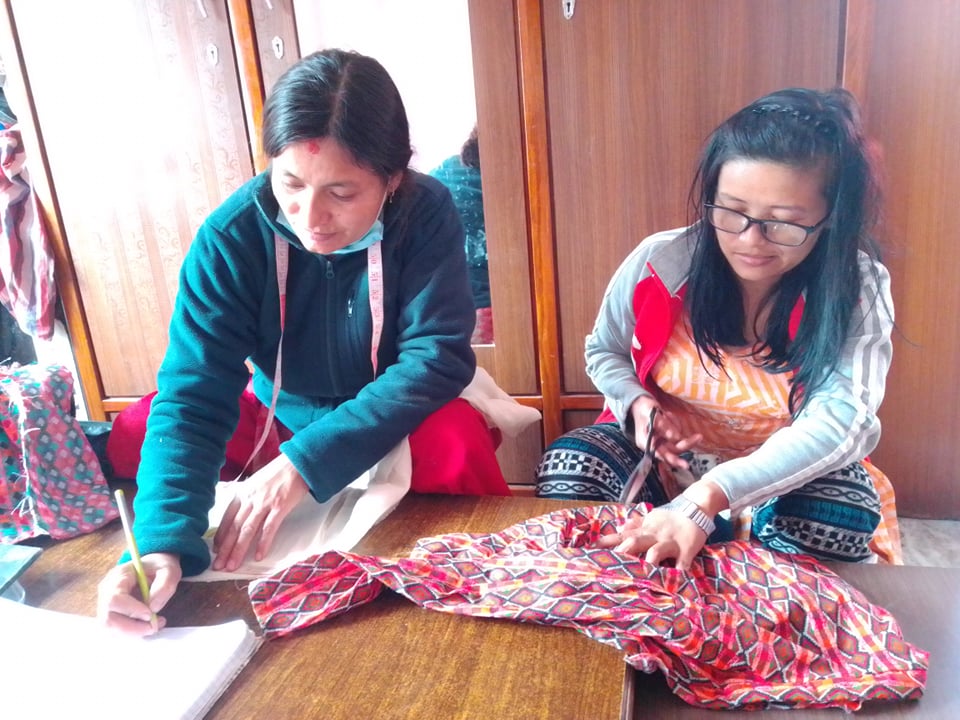 Laxmi Maharjan teaching shelter participant - Right Side Jenisha.